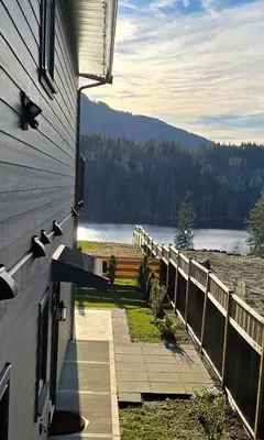 a house with a balcony with a view of a lake at Lakeview Escape in Northshore Estates in Lake Cowichan