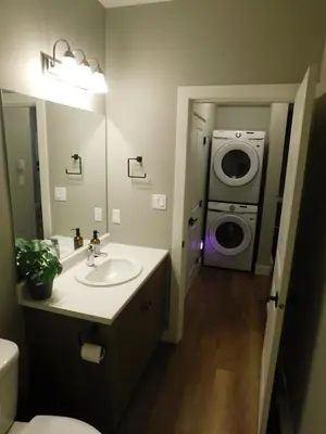 a bathroom with a sink and a washing machine at Lakeview Escape in Northshore Estates in Lake Cowichan