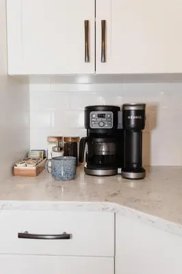 a kitchen counter with a coffee maker on top of it at The Après Arcade in Sun Peaks