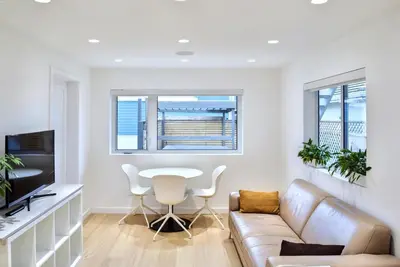 a living room with a couch and a table at Modern Private Suite with Parking - Cambie Village VGH in Vancouver