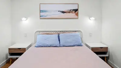 a bedroom with a bed with two nightstands at Modern Private Suite with Parking - Cambie Village VGH in Vancouver