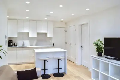 a kitchen with white cabinets and a white counter top at Modern Private Suite with Parking - Cambie Village VGH in Vancouver