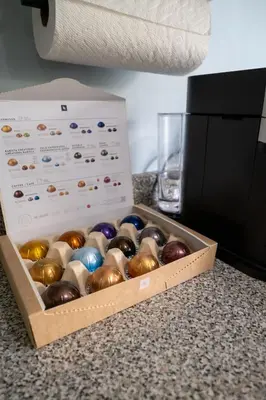 a box of colored glass ornaments sitting on a counter at 2 bedroom suite Walk to SkyTrain, Grocery, Macdonald & more in Vancouver