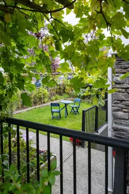 a balcony with two blue chairs and a table at 2 bedroom suite Walk to SkyTrain, Grocery, Macdonald & more in Vancouver