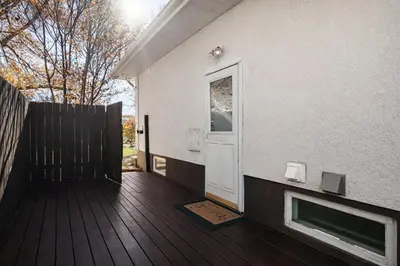 a porch of a house with a fireplace and a door at New 2BR Suite, Walk to Dining, Near Downtown in Calgary