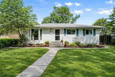 a house with a green lawn at New 2BR Suite, Walk to Dining, Near Downtown in Calgary