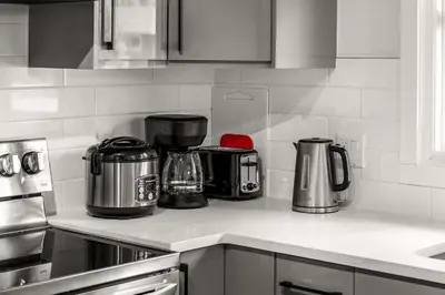 a kitchen counter with pots and pans on it at Bright 5-Bed Retreat Near the Zoo and Downtown in Calgary
