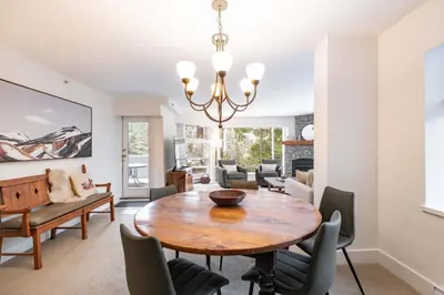 a dining room with a table and chairs at Woodrun Lodge 108 by Outpost Whistler in Whistler