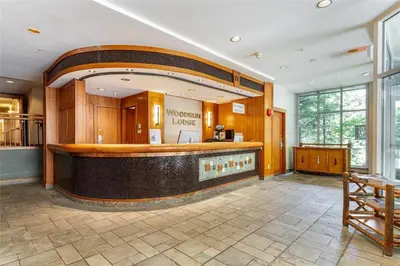 a large room with a bar with a mirror at Woodrun Lodge 108 by Outpost Whistler in Whistler