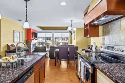 a kitchen with a sink and a counter top at Exciting Rockies 1BR Escape with Hot Tub, Pool and BBQ in Canmore