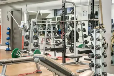 a gym with a lot of equipment at Mountain View Escape Sleeps 6 with Hot Tub and Pool in Canmore