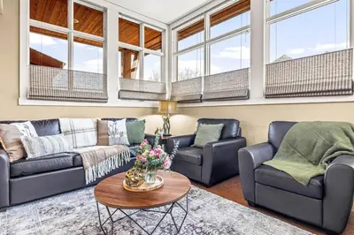 a living room with two couches and a table at Cozy 2BR Retreat Mountain View with Pool and Hot Tub in Canmore