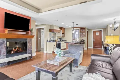 a living room with a couch and a fireplace at Spacious Rockies Escape near Banff Hot tub and Gym in Canmore