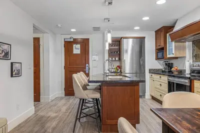a kitchen with a sink and a counter top at Spacious 2BR Oasis with Pool and Gym Close to Banff in Canmore
