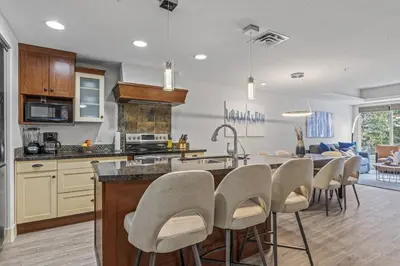 a kitchen and dining room with a table and chairs at Spacious 2BR Oasis with Pool and Gym Close to Banff in Canmore