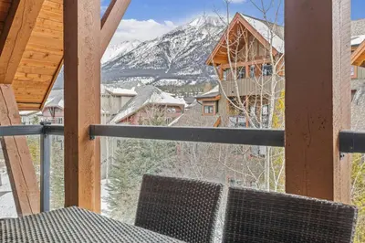 a view of a snowy mountain from a balcony at Mountain View Penthouse with Pool and Hot Tub in Canmore