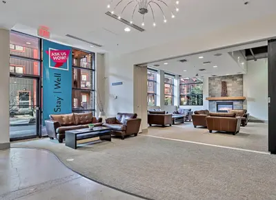 a lobby with couches and chairs in a building at Mountain View Penthouse with Pool and Hot Tub in Canmore