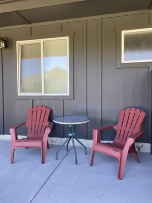 two red chairs and a table in a patio at Similkameen Valley Resort in Cawston