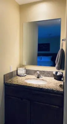 a bathroom with a sink and a large mirror at Similkameen Valley Resort in Cawston