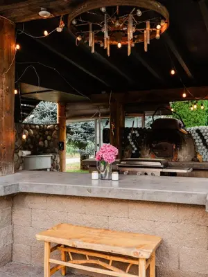 a kitchen with a counter with a table and flowers at Similkameen Valley Resort in Cawston
