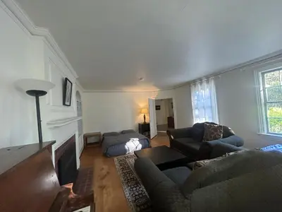 a living room with a couch and a bed at Vancouver Guest House - Airport 10 Min, Downtown 15 Min - Free Parking & Fast Wi-Fi in Vancouver