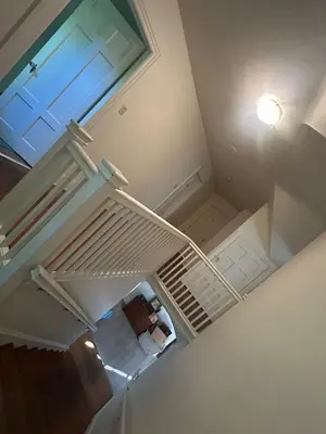 an overhead view of a white staircase with a window at Vancouver Guest House - Airport 10 Min, Downtown 15 Min - Free Parking & Fast Wi-Fi in Vancouver
