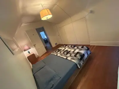 a bedroom with a bed in the middle of a room at Vancouver Guest House - Airport 10 Min, Downtown 15 Min - Free Parking & Fast Wi-Fi in Vancouver