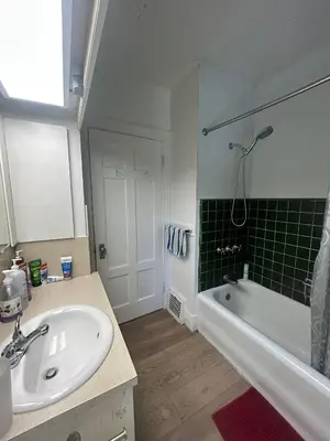 a bathroom with a sink and a bath tub at Vancouver Guest House - Airport 10 Min, Downtown 15 Min - Free Parking & Fast Wi-Fi in Vancouver
