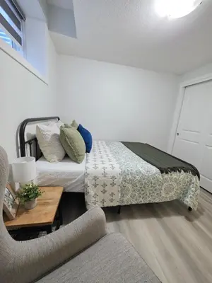 a bedroom with a bed and a couch at Amaville - Two BRM Suite in West Edmonton in Edmonton