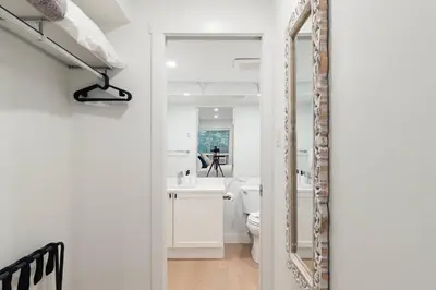 a bathroom with a toilet and a sink and a mirror at Private Hot Tub | Pool | Free Parking | Sauna in Whistler