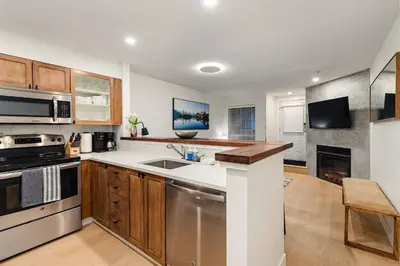 a kitchen with a sink and a stove at Private Hot Tub | Pool | Free Parking | Sauna in Whistler