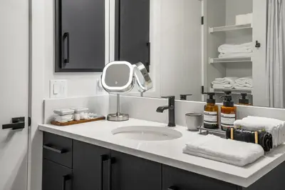 a bathroom with a sink and a mirror at King Bed, Full Kitchen, Free Parking, Family Friendly Dining, Workspace & Fast Wi-fi - Private Basement Suite in Calgary