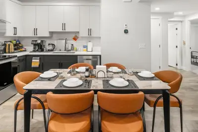 a dining room with a table and chairs in a kitchen at King Bed, Full Kitchen, Free Parking, Family Friendly Dining, Workspace & Fast Wi-fi - Private Basement Suite in Calgary
