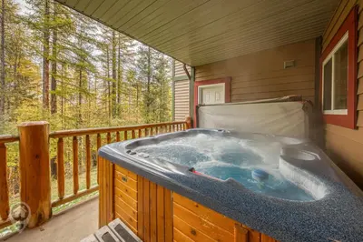 a jacuzzi tub on the deck of a cabin at Kimberley Ridge by StayIn in Kimberley