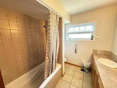 a bathroom with a tub and a sink and a shower at Downtown Central City Cozy Private 2 Bedroom Basement Suite - Independent Entry in Surrey