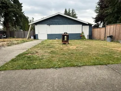 a house with a mailbox in a yard at Downtown Central City Cozy Private 2 Bedroom Basement Suite - Independent Entry in Surrey