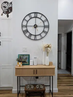 a large clock on a wall above a table at Serenity on the Vista's Point at Lac La Nonne in Onoway