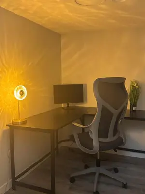 an office with a desk with a chair and a lamp at Modern comfort just 20 minutes from the airport, with a full kitchen in Edmonton
