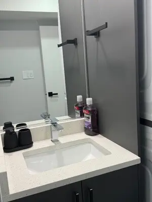 a bathroom with a sink and a mirror at Modern comfort just 20 minutes from the airport, with a full kitchen in Edmonton