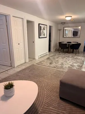 a living room with a couch and a table at Newly Renovated - Self contained Suite - Sleeps 6 in Vancouver