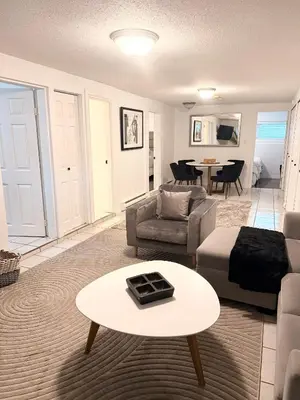a living room with a couch and a table at Newly Renovated - Self contained Suite - Sleeps 6 in Vancouver