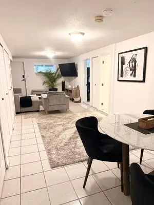 a living room with a table and a couch at Newly Renovated - Self contained Suite - Sleeps 6 in Vancouver