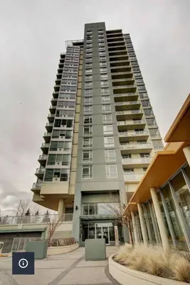 a tall apartment building with a lot of windows at The Spruce Modern 2BR Condo with Pool & Parking in Calgary