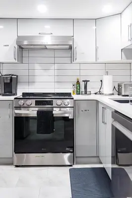 a kitchen with a stainless steel stove top oven at Superior and Spacious 2-bedroom basement private suite in Edmonton