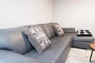 a gray couch with pillows on it in a living room at Superior and Spacious 2-bedroom basement private suite in Edmonton