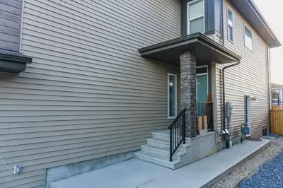 a house with a staircase on the side of it at Superior and Spacious 2-bedroom basement private suite in Edmonton