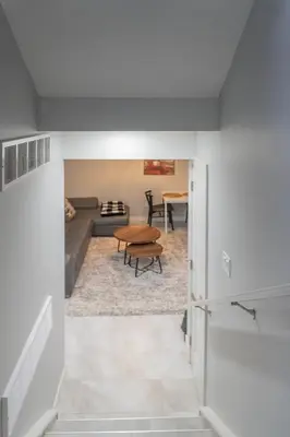 a living room with a table and a couch at Superior and Spacious 2-bedroom basement private suite in Edmonton