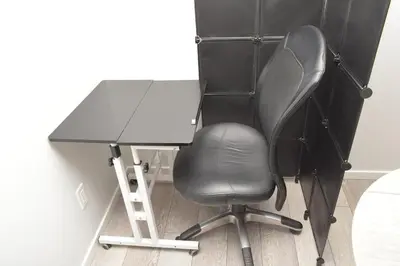a black desk with a chair and a ladder at Beautiful Basement Suite in Stillwater, West Edmonton in Edmonton