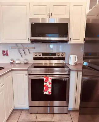 a kitchen with a stainless steel oven with a microwave at Stunning Mountain View in Fairmont Hot Springs