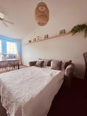 a bedroom with a bed with a white comforter at Stunning Mountain View in Fairmont Hot Springs